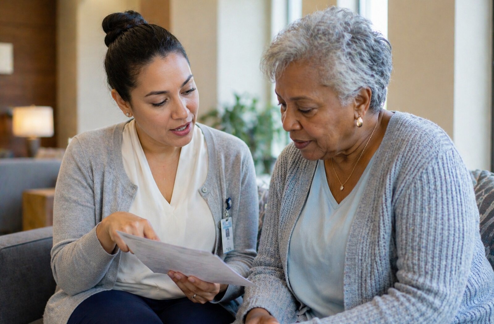 A healthcare worker showing information on a clipboard to an older patient